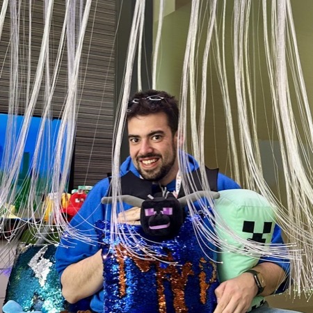 Alex with Minecraft plushies — gaming culture is part of the identity.